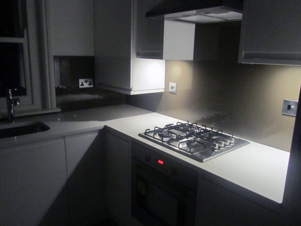 Pure White [CAESARSTONE] quartz kitchen worktops with brown glass splashbacks Chiswick