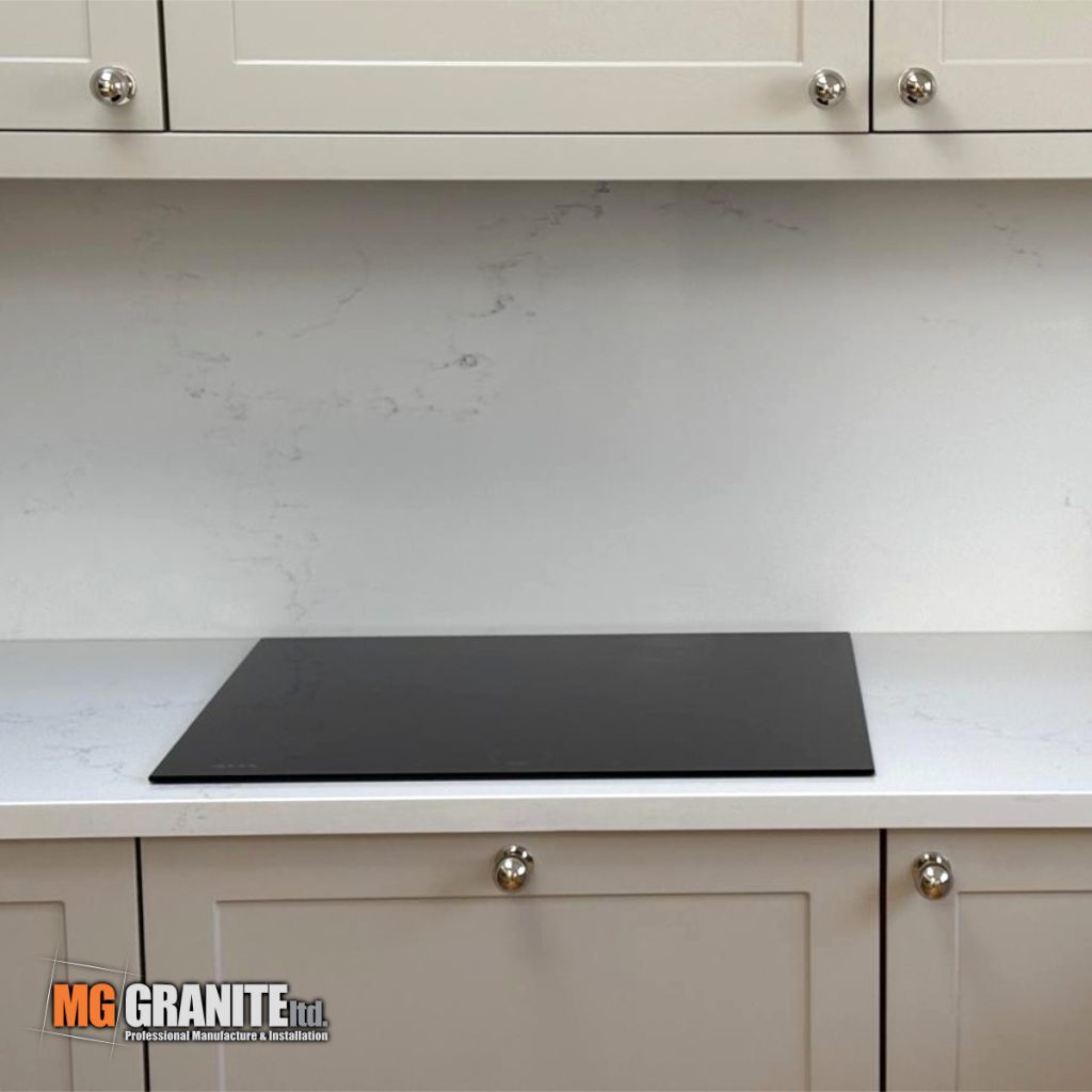 Side angle showing the complete run of the L-shaped Classic Quartz Mystery worktop layout in the Morden home.