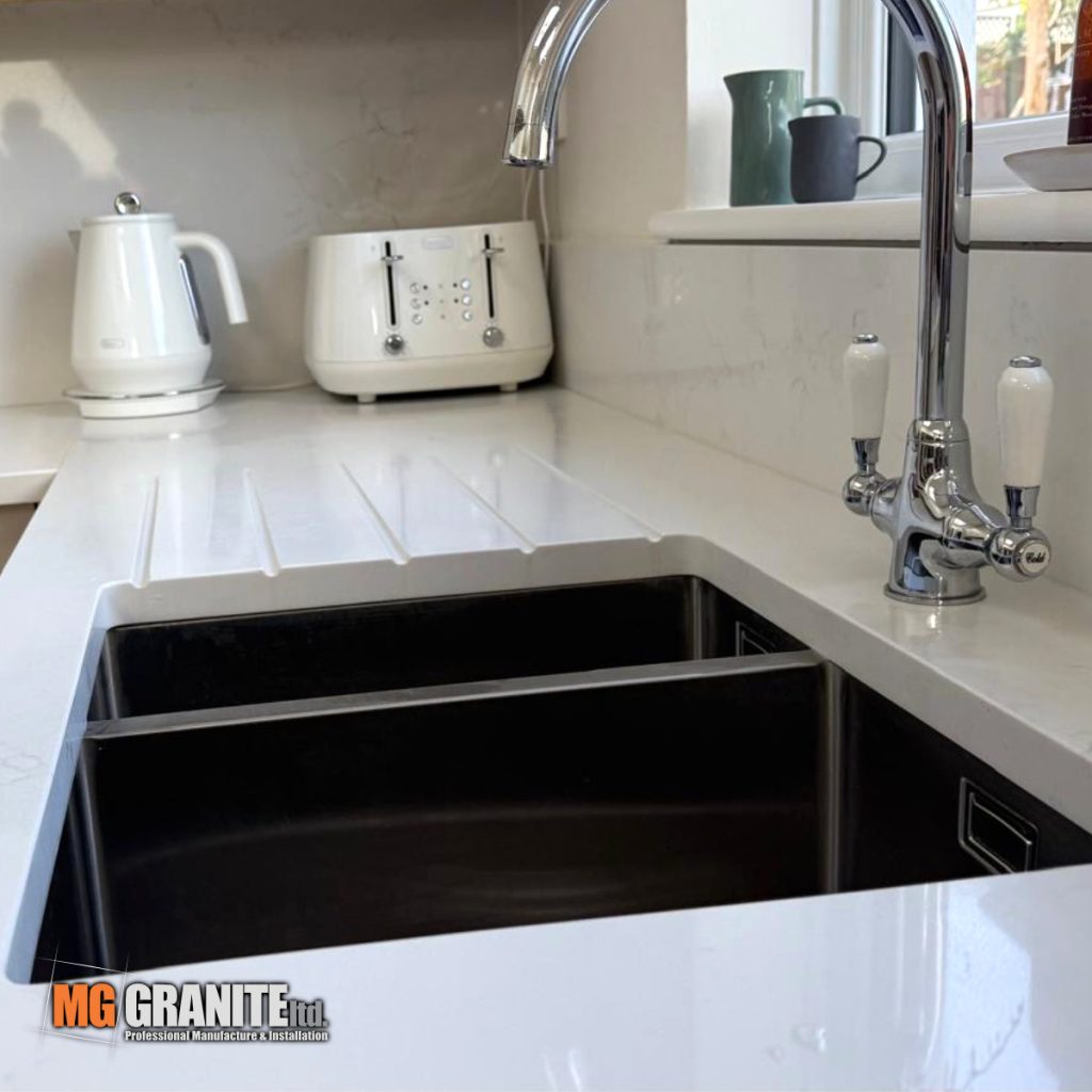 Flawless under-mount sink cut-out with integrated drainage grooves in a Classic Quartz Mystery stone countertop.